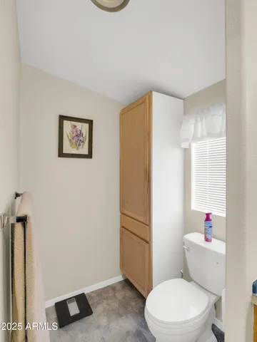 a white toilet sitting next to a bathroom sink