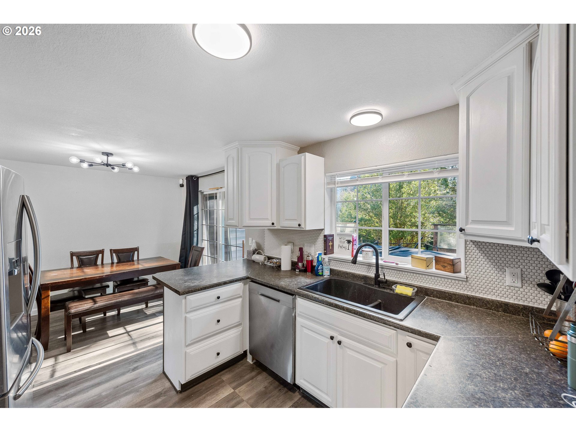 1643 Shelley Road Coquille, OR 97423 - Photo 12 of 39 a kitchen with kitchen island white cabinets and a large window