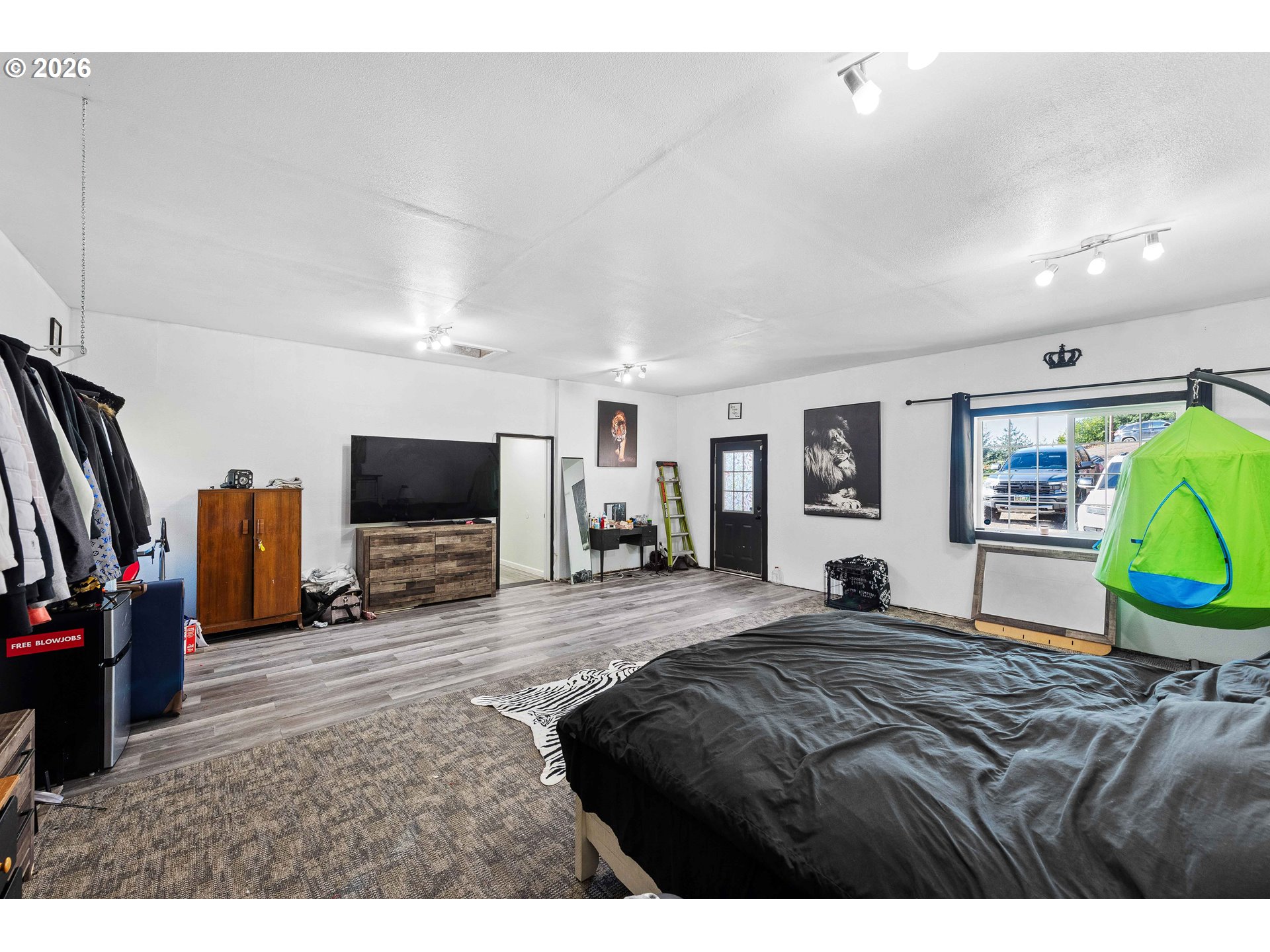 1643 Shelley Road Coquille, OR 97423 - Photo 15 of 39 a bedroom with a bed a television and a large window