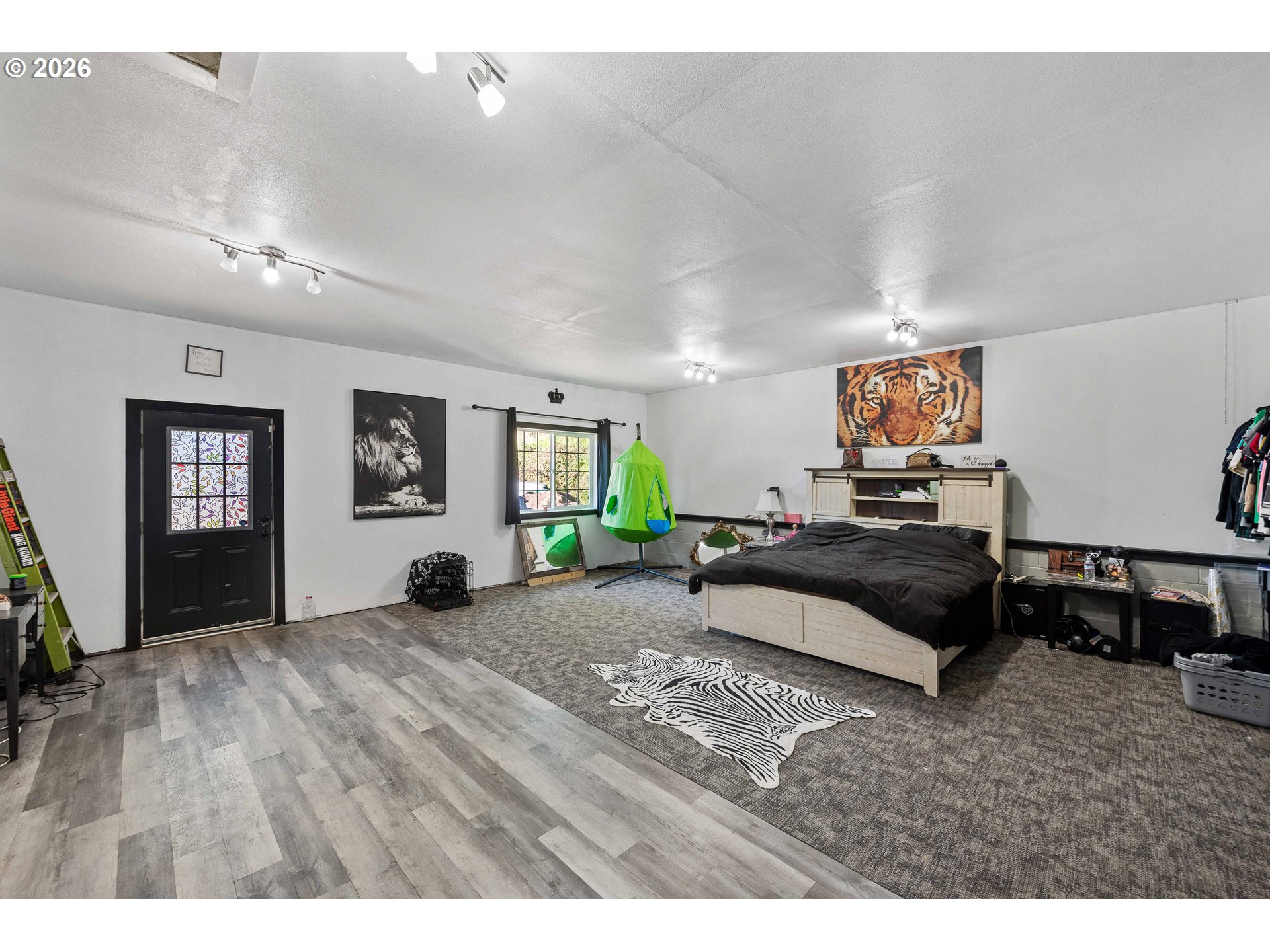 1643 Shelley Road Coquille, OR 97423 - Photo 16 of 39 a spacious bedroom with a bed a couch and a window