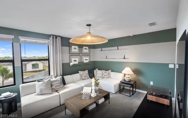 a living room with furniture and a chandelier