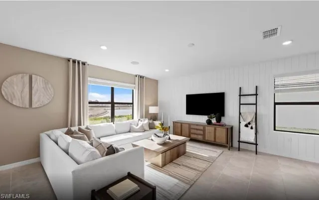 a living room with furniture and a flat screen tv