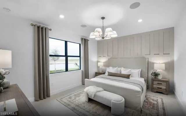 a bedroom with a bed and a chandelier