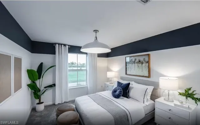 a bedroom with a large bed and a chandelier