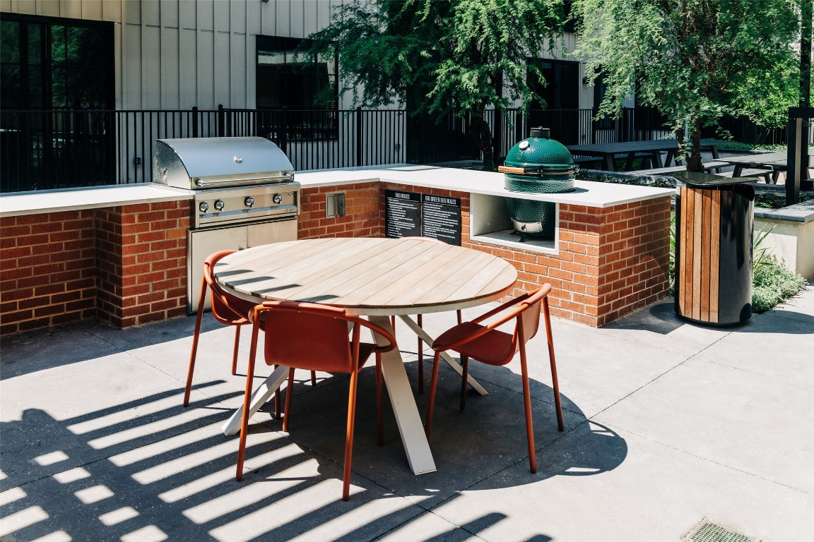 4315 South Congress Avenue, Unit 308 Austin, TX 78745 - Photo 15 of 20 a view of a patio with table and chairs with plants and wooden fence