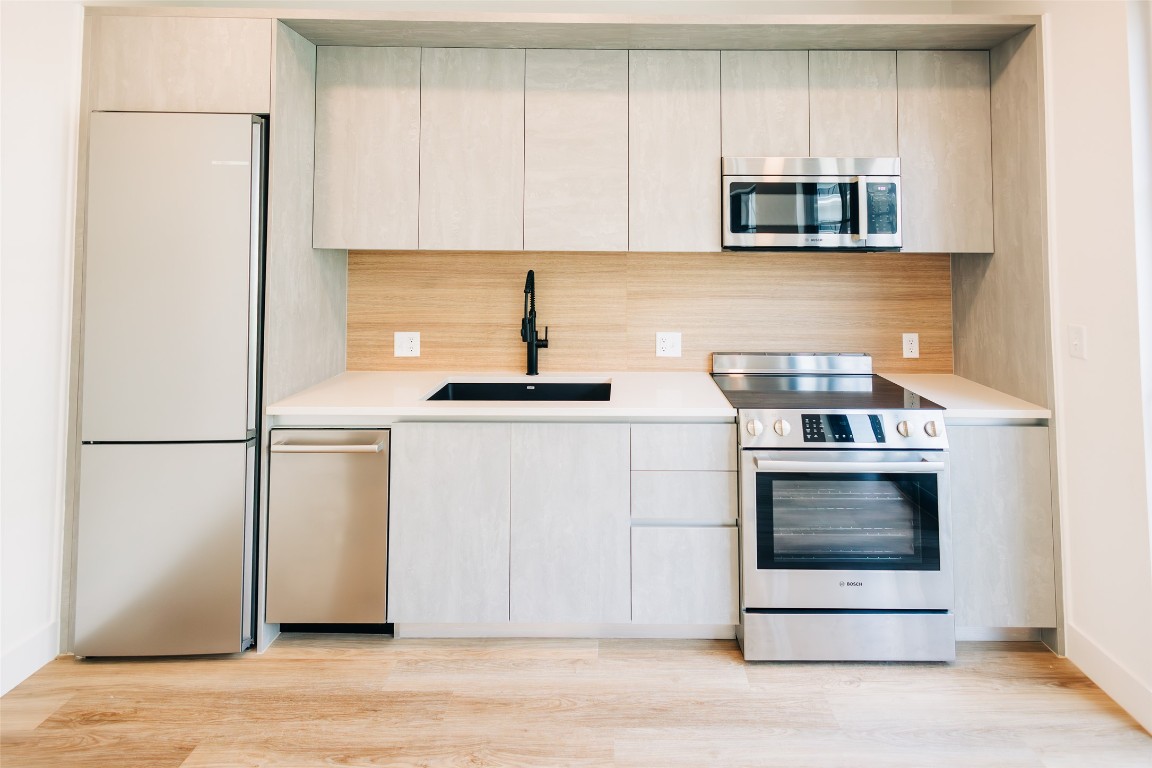 4315 South Congress Avenue, Unit 308 Austin, TX 78745 - Photo 4 of 20 a kitchen with a stove and a microwave