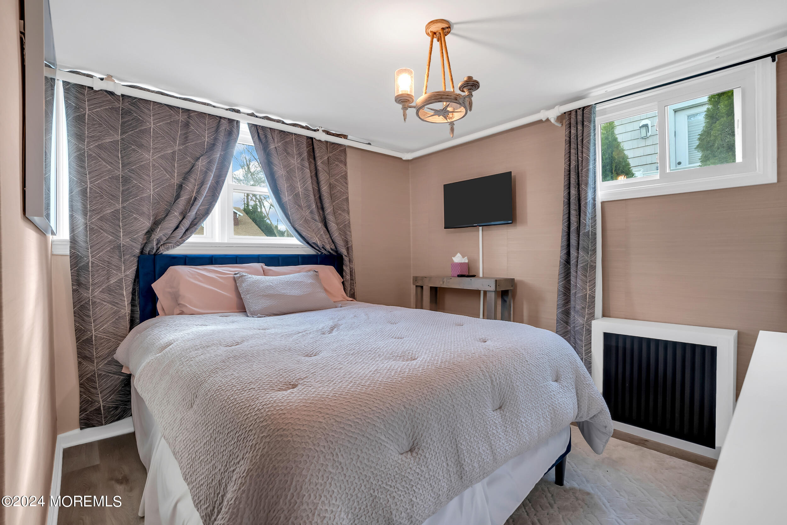 201 Buttermere Avenue Interlaken, NJ 07712 - Photo 17 of 39 a bedroom with a bed and a flat tv screen