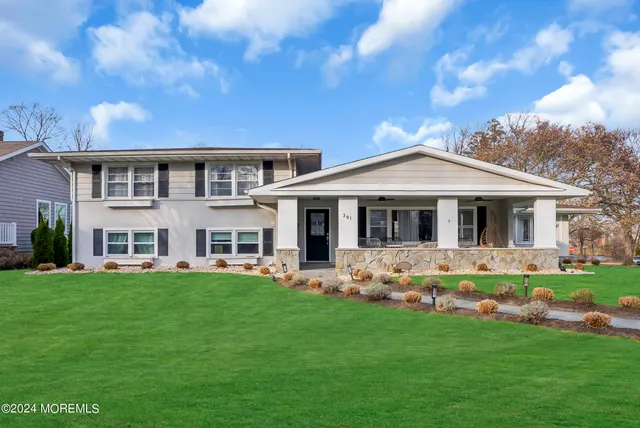 a front view of a house with a garden