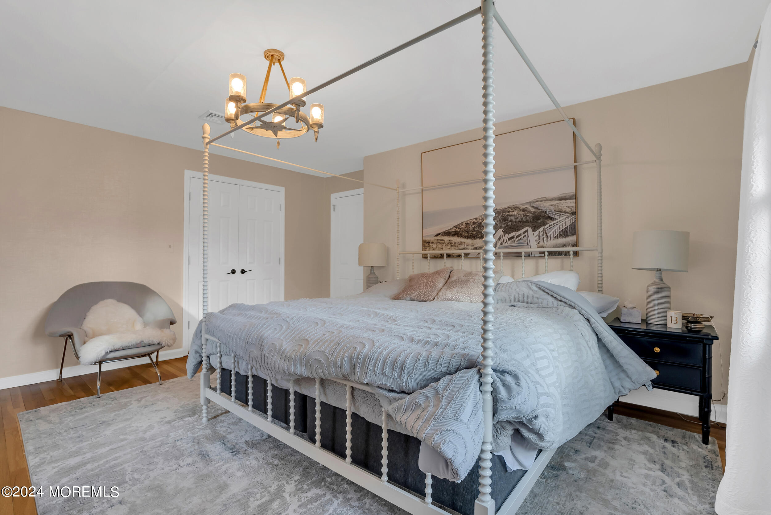 201 Buttermere Avenue Interlaken, NJ 07712 - Photo 22 of 39 a bedroom with a bed window and a chandelier