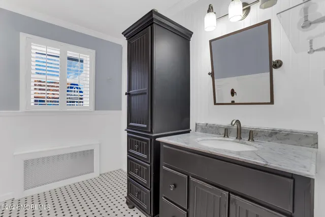a bathroom with a sink a vanity and a mirror