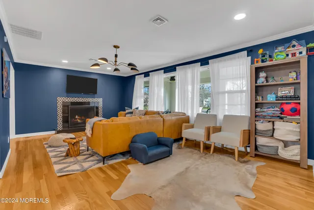 a bed room with a bed furniture and a flat tv screen