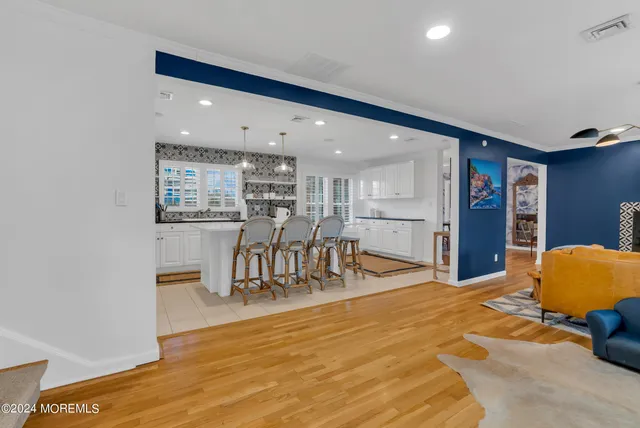 a living room with stainless steel appliances kitchen island granite countertop furniture and a kitchen view