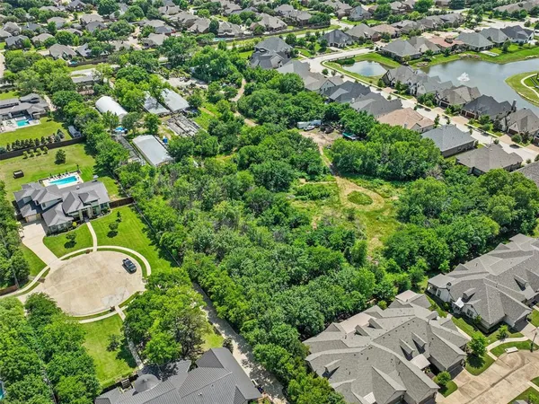 an aerial view of a house with yard