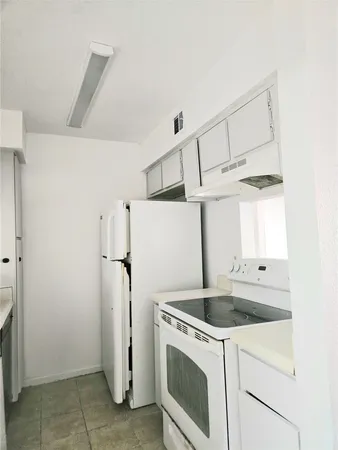 a view of a kitchen from a hallway