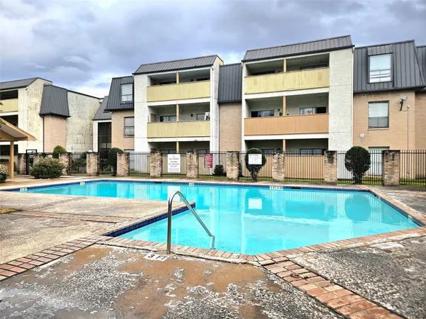 a view of an house with swimming pool and sitting area