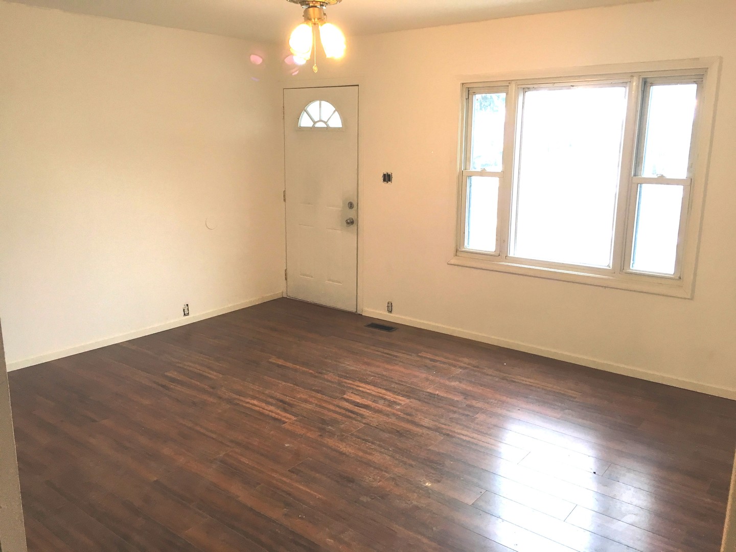 420 Arlington Drive Romeoville, IL 60446 - Photo 3 of 19 an empty room with wooden floor and windows