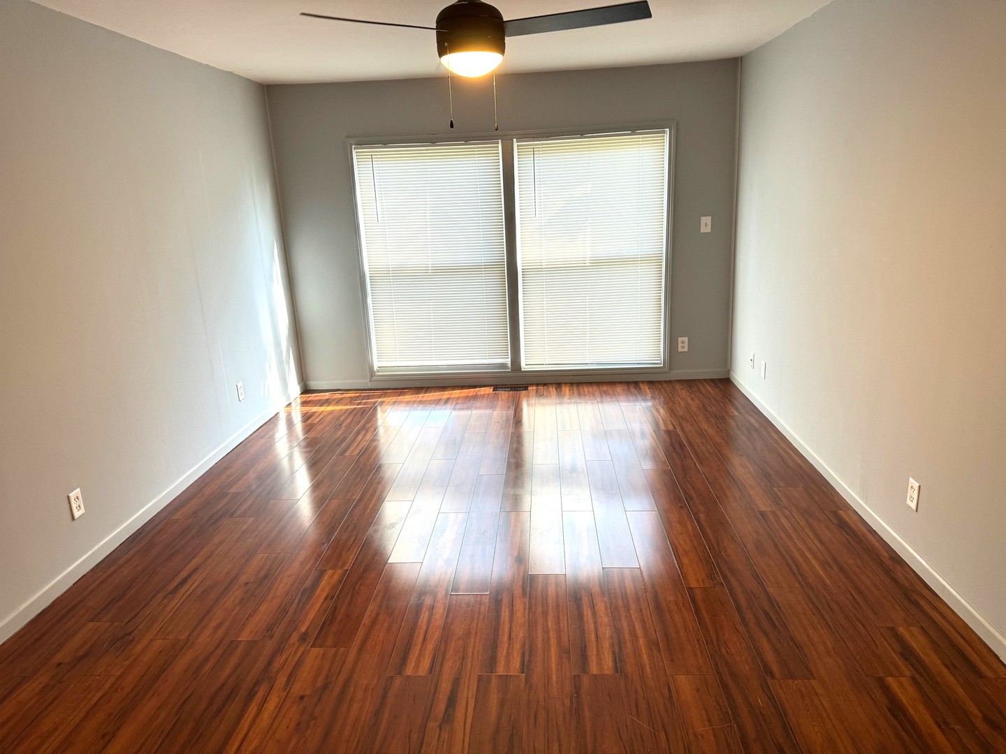 420 Arlington Drive Romeoville, IL 60446 - Photo 7 of 19 an empty room with wooden floor and windows