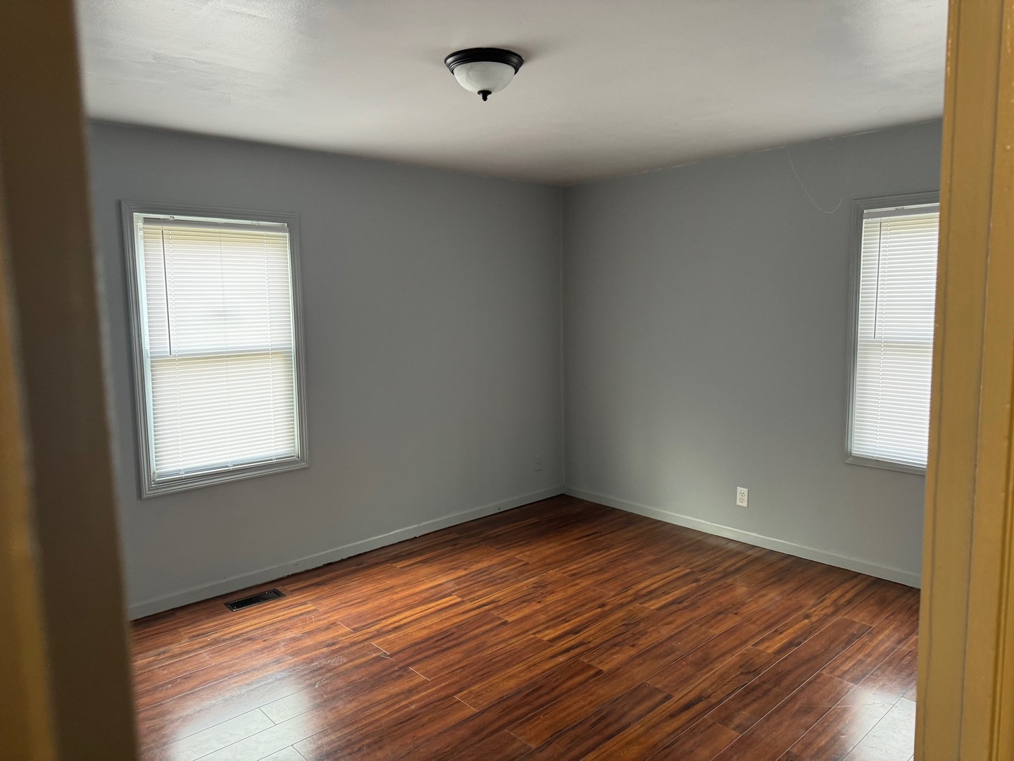 420 Arlington Drive Romeoville, IL 60446 - Photo 8 of 19 an empty room with wooden floor and windows