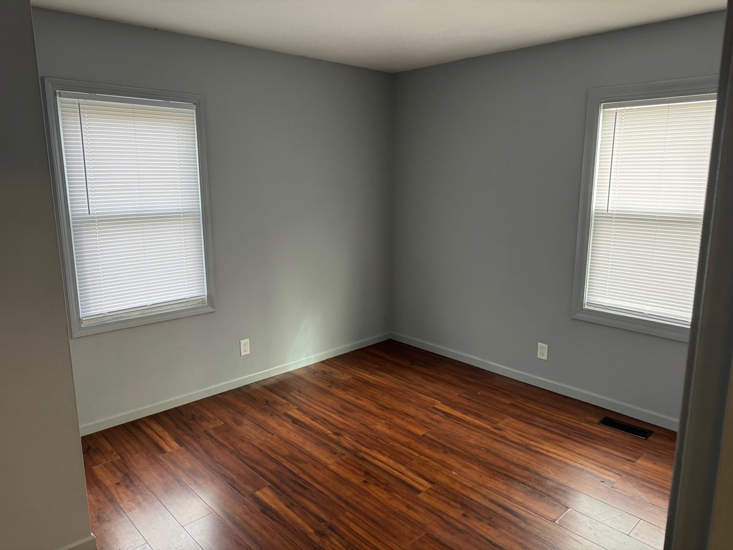 420 Arlington Drive Romeoville, IL 60446 - Photo 9 of 19 an empty room with wooden floor and windows