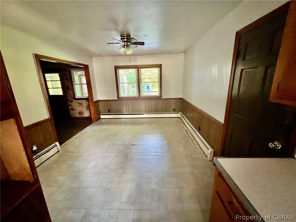 1642 Regent Road Topping, VA 23169 - Photo 9 of 10 Dining area off the kitchen ceiling fan, a baseboard radiator, and light tile flooring