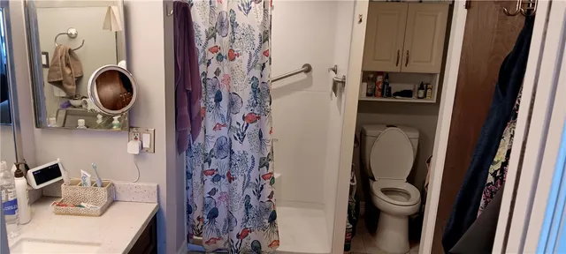 a bathroom with a sink toilet and a mirror