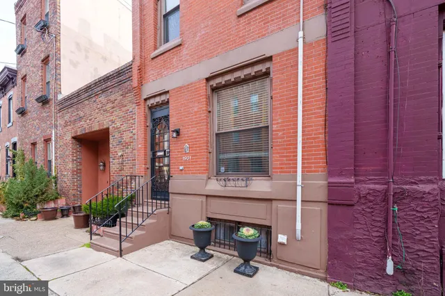 a view of a brick building with a bench in front of building