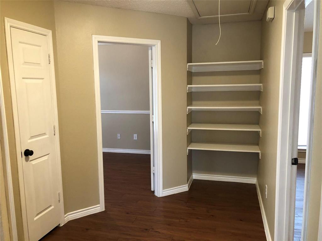 8301 Bells Street Frisco, TX 75035 - Photo 17 of 24 a view of walk in closet with empty racks