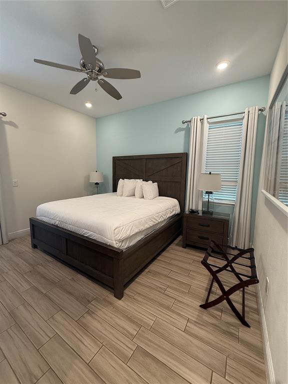 2986 Salted Rim Road Kissimmee, FL 34747 - Photo 30 of 36 a bedroom with a bed wooden floor and window
