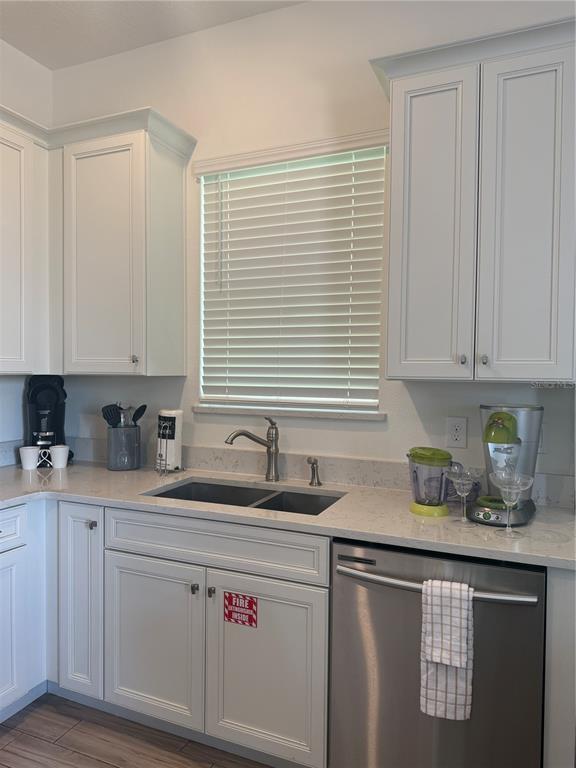2986 Salted Rim Road Kissimmee, FL 34747 - Photo 9 of 36 a kitchen with stainless steel appliances granite countertop white cabinets a sink and dishwasher