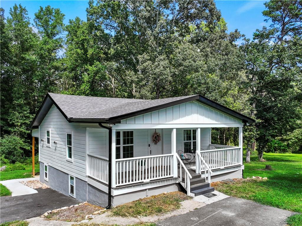 3621 Lebanon Church Road Gillsville, GA 30543 - Photo 1 of 1 a view of a house with a yard and large tree