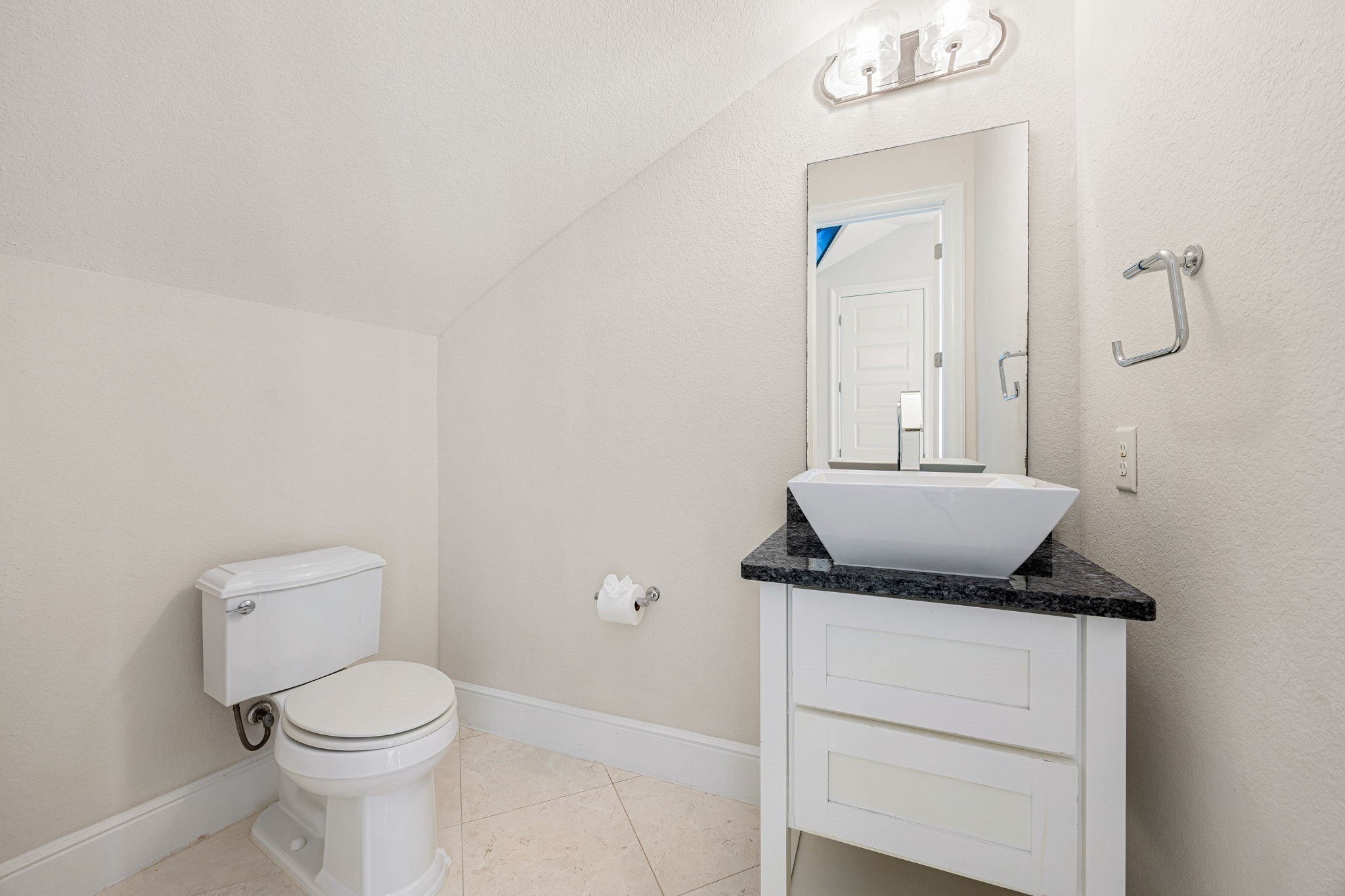 2102 Granite Brook Lane Katy, TX 77494 - Photo 15 of 39 This charming half bath features a sleek modern vanity with a vessel sink, granite countertop, elegant lighting, and neutral tones, the perfect blend of style and functionality for guests.