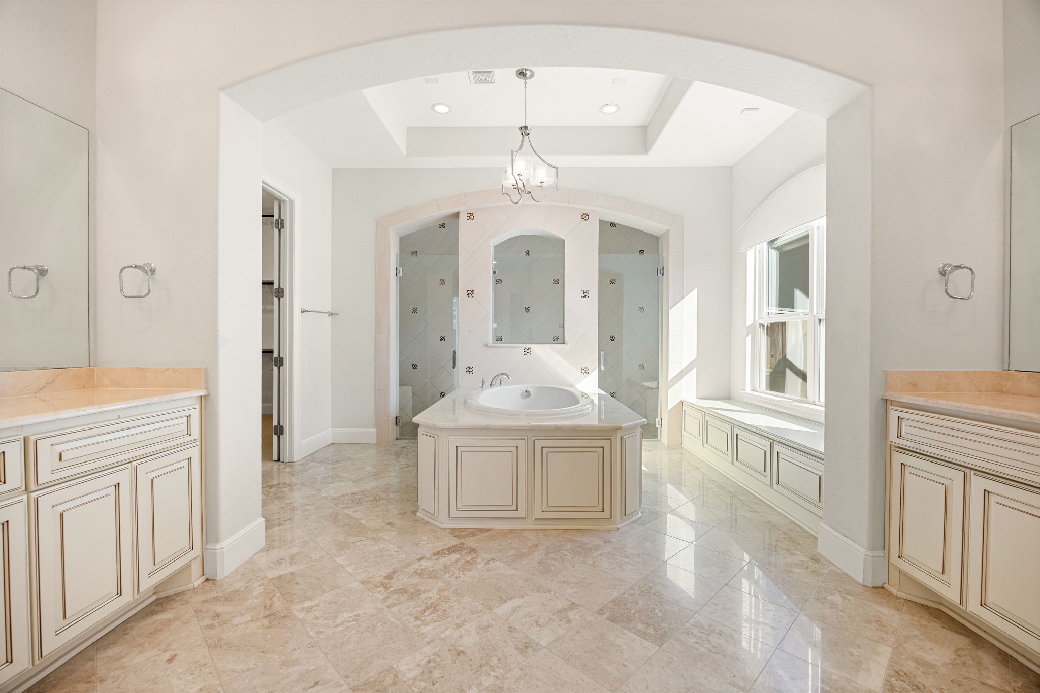 2102 Granite Brook Lane Katy, TX 77494 - Photo 17 of 39 Your dream primary bathroom awaits! Featuring a stunning garden tub as the focal point, dual vanities with elegant finishes, high ceilings, custom lighting, and gorgeous marble tile floors that create a spa-like atmosphere.