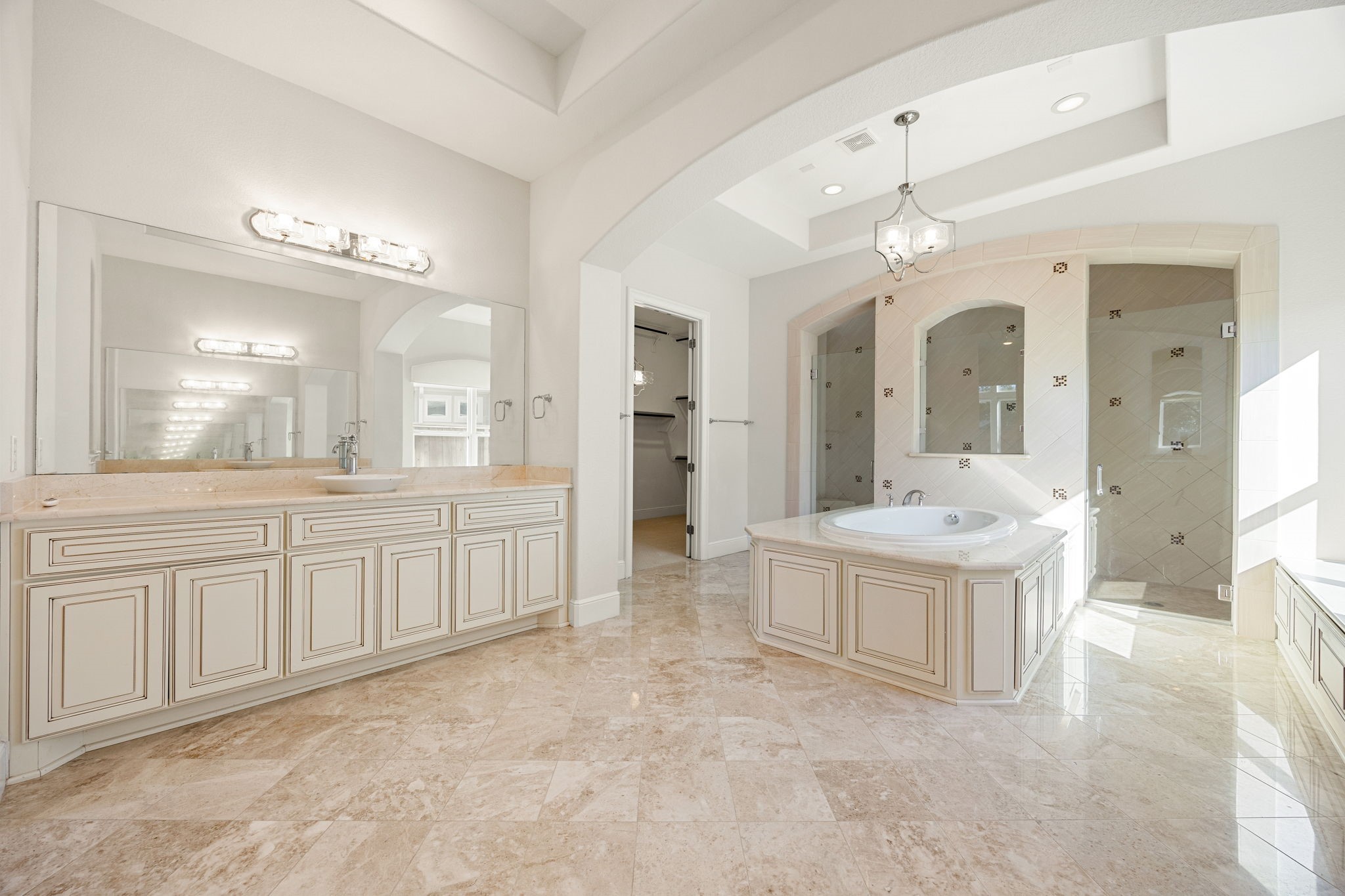 2102 Granite Brook Lane Katy, TX 77494 - Photo 19 of 39 This luxurious primary bath offers everything you need to unwind! Enjoy the garden tub with tile detailing, dual vanities with plenty of storage space, high ceilings, and a spacious walk-in shower designed for both style and comfort.