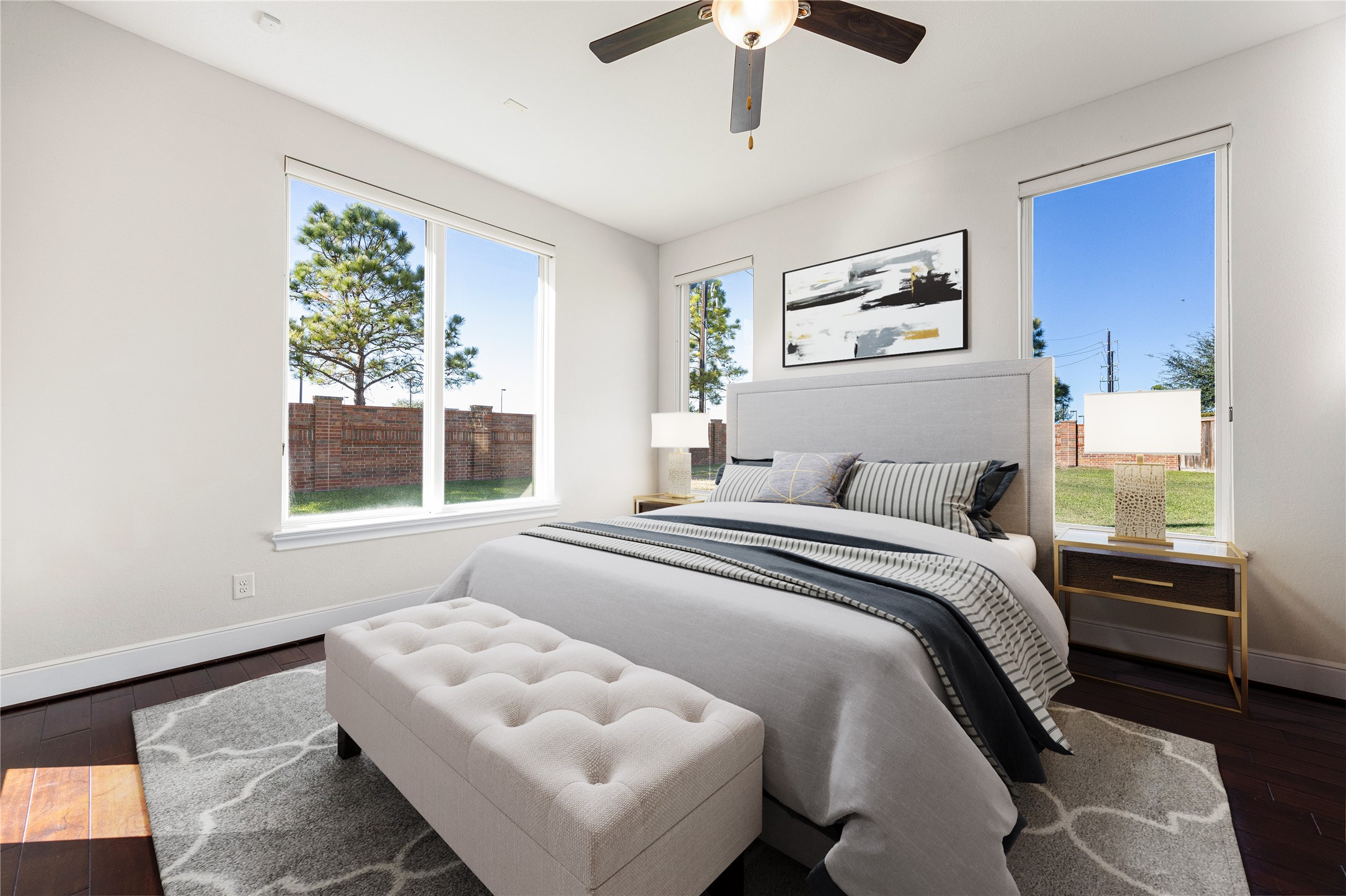 2102 Granite Brook Lane Katy, TX 77494 - Photo 21 of 39 This spacious secondary bedroom features large windows that fill the room with natural light, neutral tones, high ceilings, and rich wood flooring, creating a bright and inviting space for family or guests. *Virtually Staged