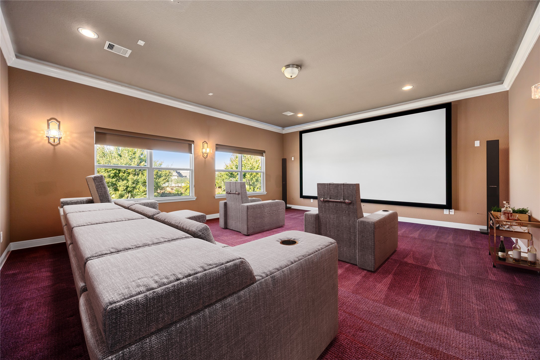2102 Granite Brook Lane Katy, TX 77494 - Photo 27 of 39 Enjoy movie nights in style in this spacious media room featuring a large projection screen, crown molding, recessed lighting, and a warm, inviting atmosphere, perfect for entertaining family and friends. *Virtually Staged