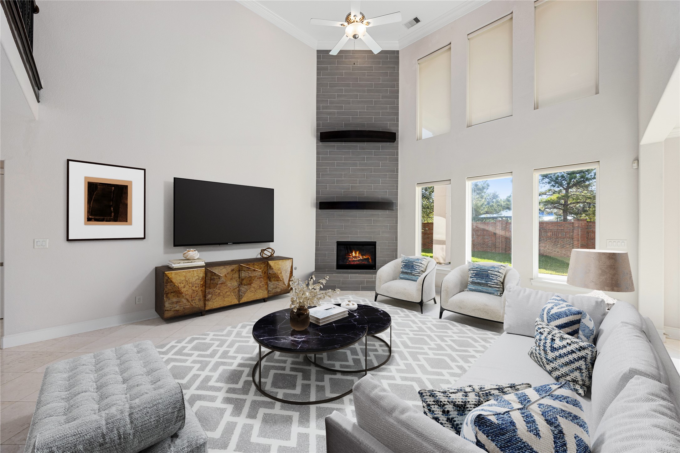 2102 Granite Brook Lane Katy, TX 77494 - Photo 9 of 39 This living room is more like a GREAT room, featuring a stunning floor-to-ceiling fireplace with modern tile detailing, soaring high ceilings, recessed lighting, elegant tile flooring, and a beautiful wall of windows providing plenty of natural light and a lovely view of the backyard, perfect for keeping an eye on kids or pets at play. *Virtually Staged