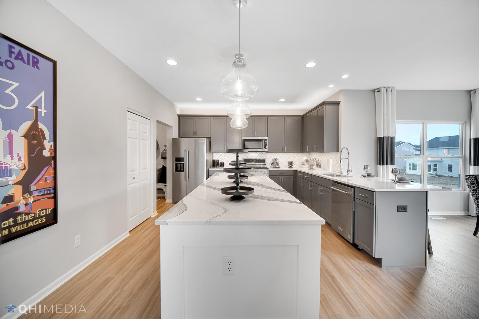 25 Levanno Drive Crown Point, IN 46307 - Photo 12 of 25 a kitchen with stainless steel appliances kitchen island a sink a stove a refrigerator cabinets and a window