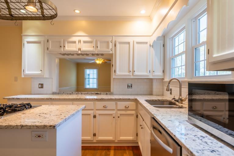 4 Jones Street Cartersville, GA 30120 - Photo 21 of 36 a kitchen with granite countertop a sink stainless steel appliances and cabinets