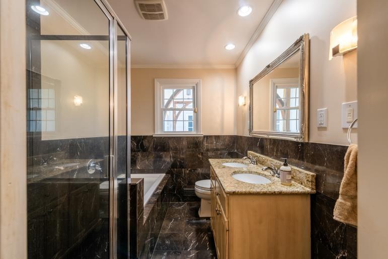 4 Jones Street Cartersville, GA 30120 - Photo 22 of 36 a bathroom with a granite countertop sink a mirror and a shower