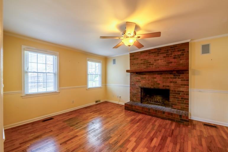 4 Jones Street Cartersville, GA 30120 - Photo 23 of 36 a view of an empty room with wooden floor fireplace and a window