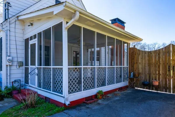 a view of a house with backyard and a tree