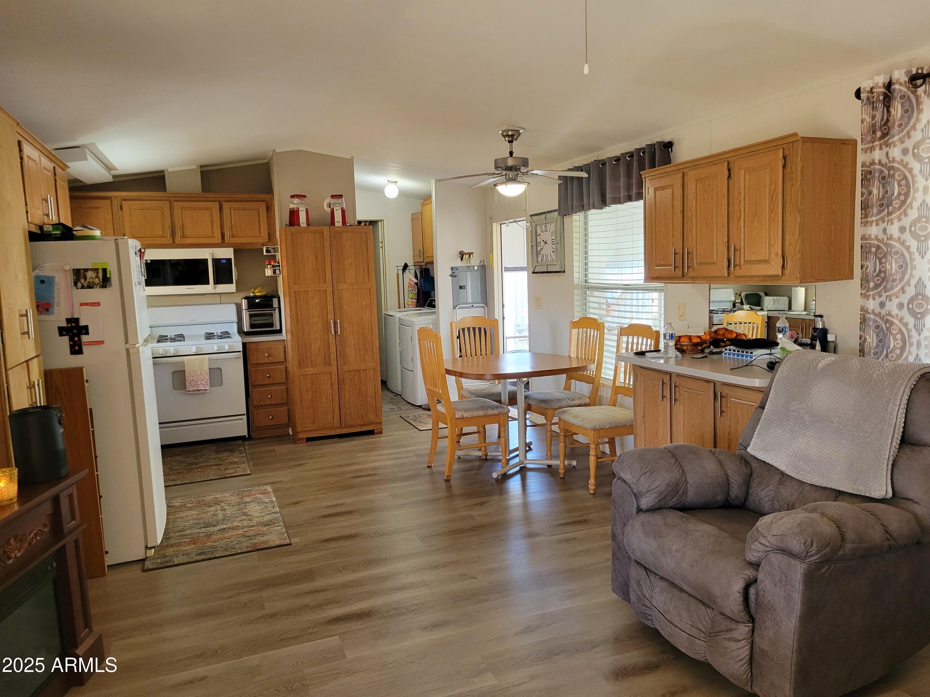 2460 East Main Street, Unit B9 Mesa, AZ 85213 - Photo 3 of 15 a living room with stainless steel appliances kitchen island granite countertop furniture and a kitchen view
