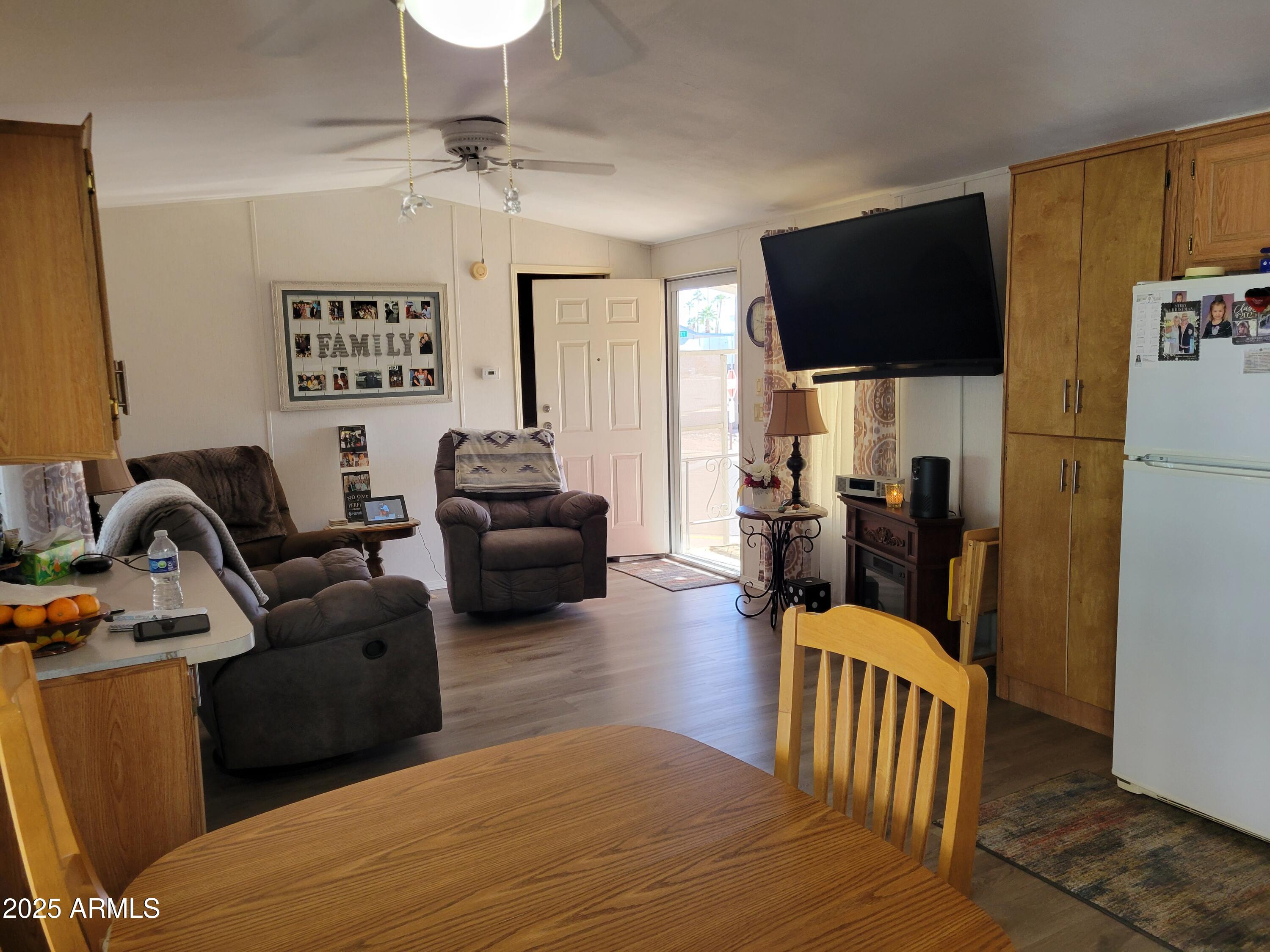 2460 East Main Street, Unit B9 Mesa, AZ 85213 - Photo 5 of 15 a living room with furniture a flat screen tv and kitchen view