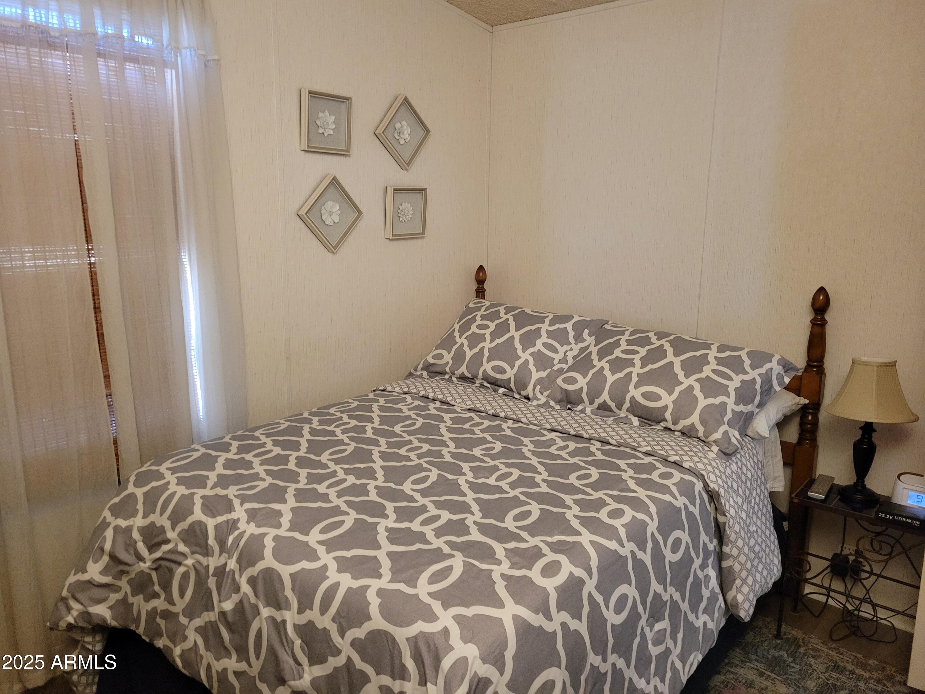 2460 East Main Street, Unit B9 Mesa, AZ 85213 - Photo 7 of 15 a large bed with a book shelf
