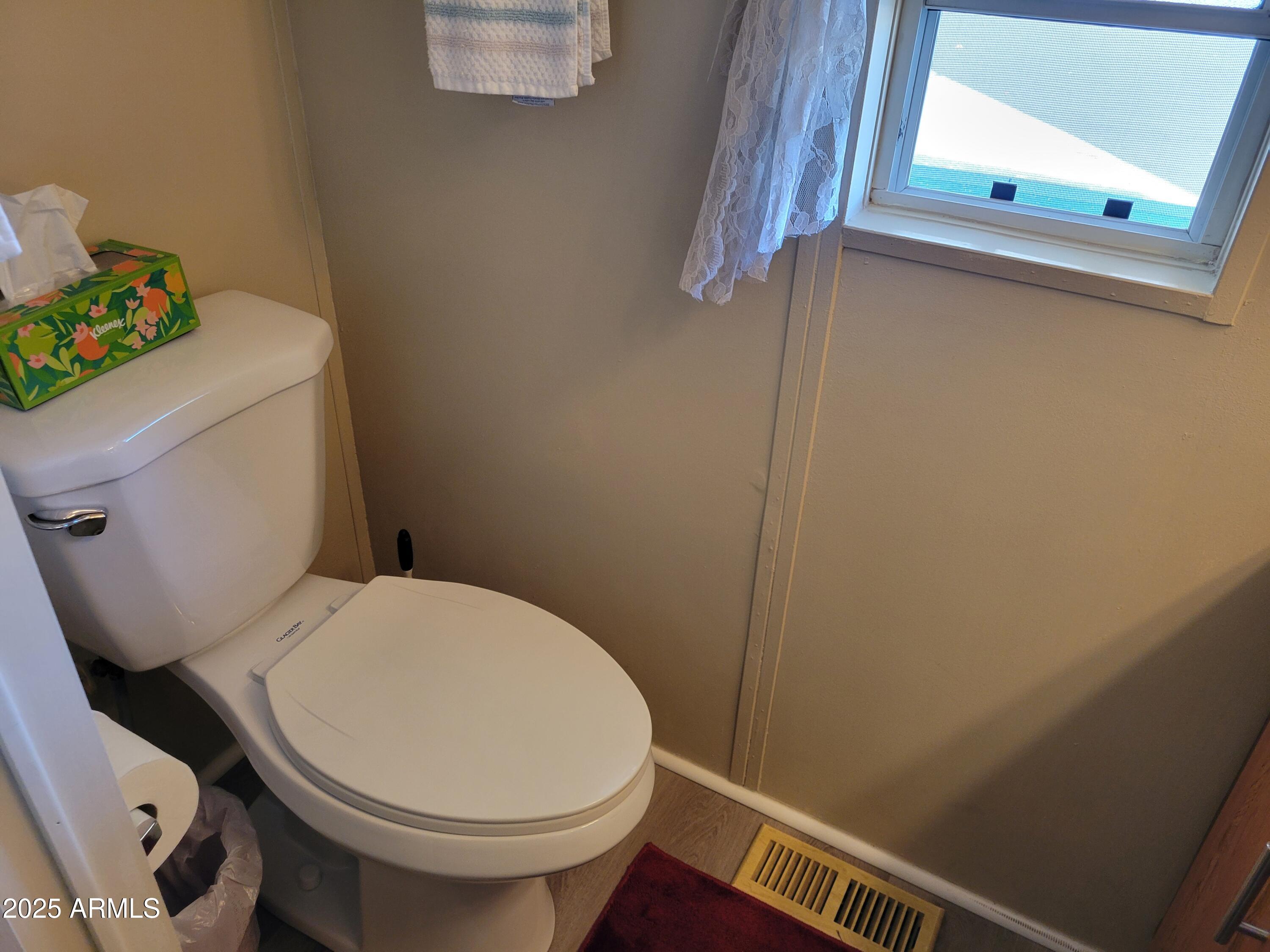 2460 East Main Street, Unit B9 Mesa, AZ 85213 - Photo 9 of 15 a white toilet sitting next to a small window