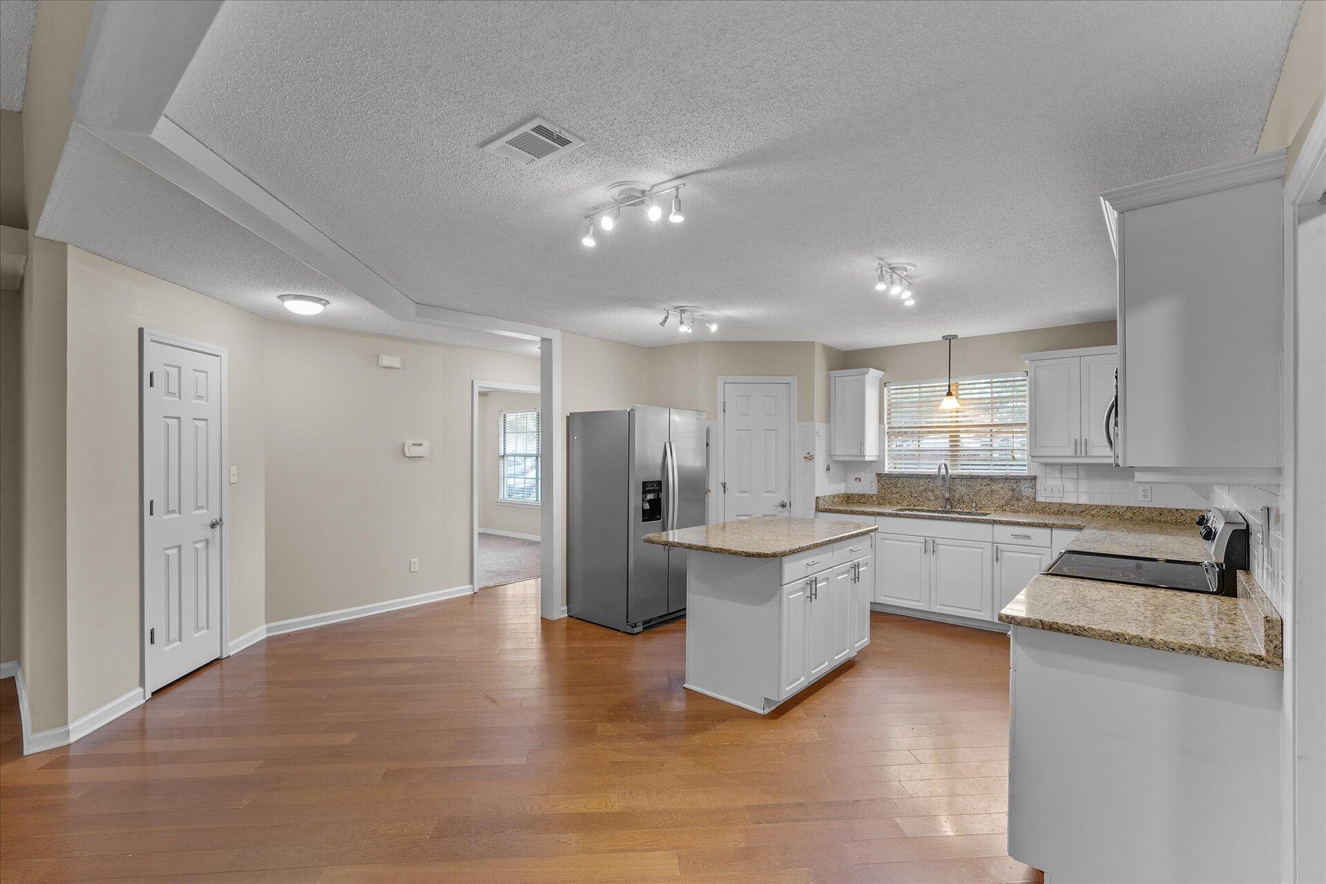 2723 Rambler Court Navarre, FL 32566 - Photo 11 of 40 a large kitchen with cabinets