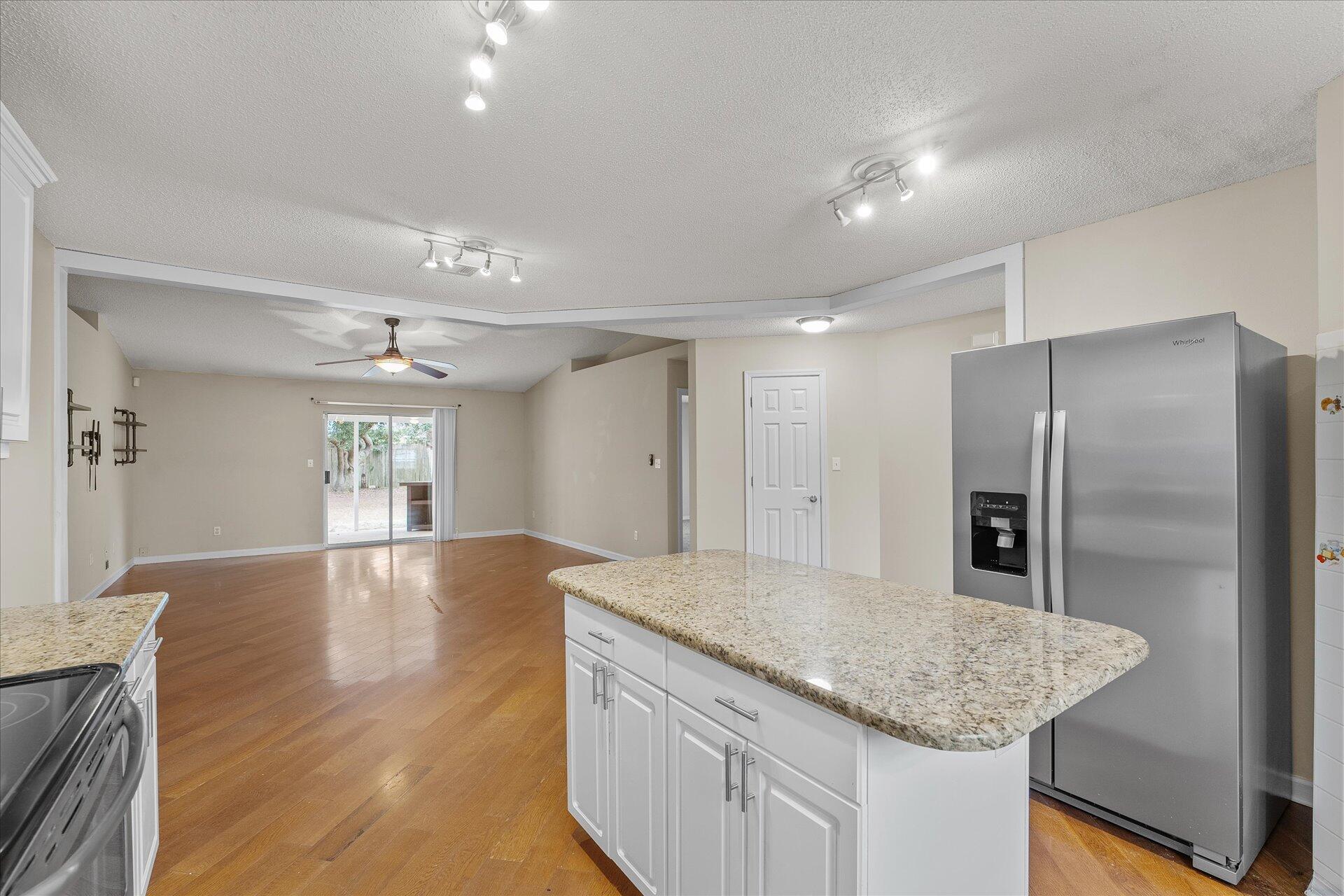 2723 Rambler Court Navarre, FL 32566 - Photo 15 of 40 a kitchen with granite countertop a refrigerator and a sink
