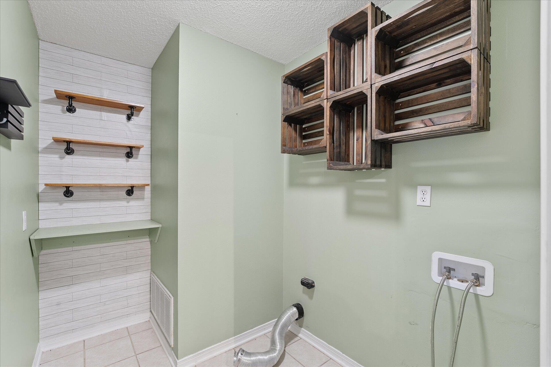 2723 Rambler Court Navarre, FL 32566 - Photo 17 of 40 a view of storage and utility room with racks on the wall