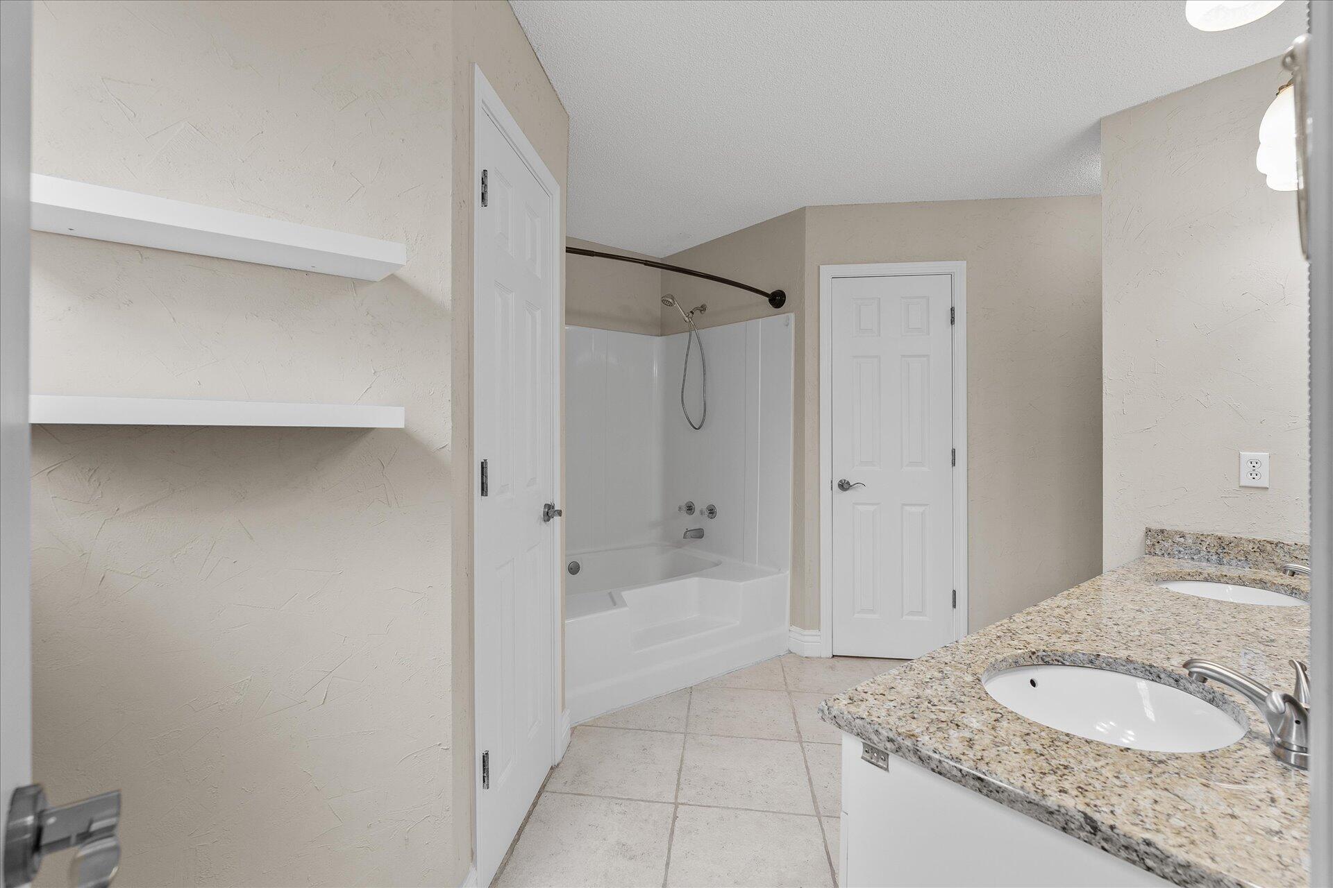 2723 Rambler Court Navarre, FL 32566 - Photo 22 of 40 a bathroom with a granite countertop sink and a mirror