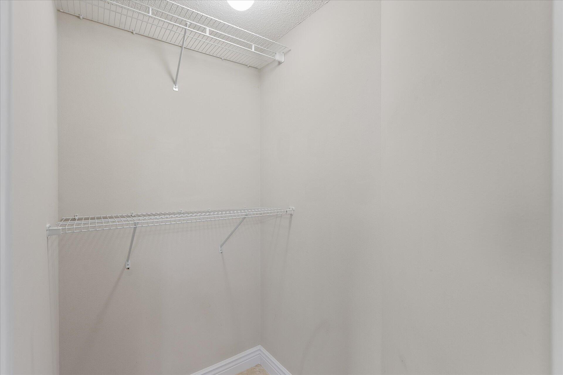 2723 Rambler Court Navarre, FL 32566 - Photo 25 of 40 a view of a room with racks on the wall